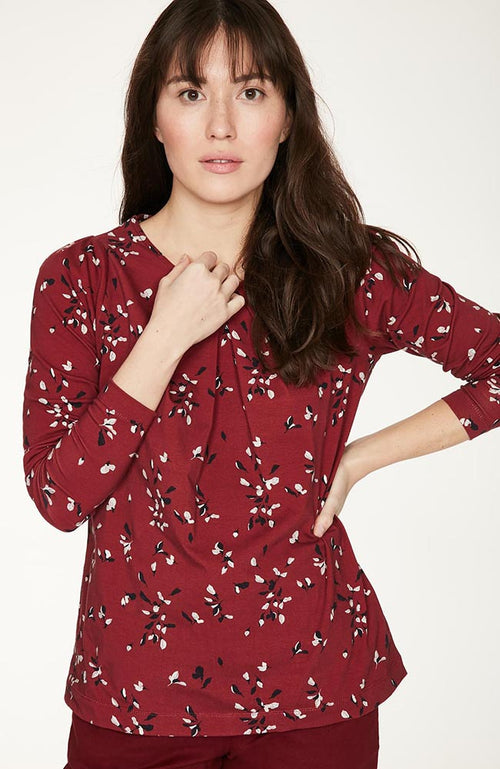 Ruby Red relaxed fit long sleeve top, with pleat detailing at front neckline and shoulder. Features a hand painted floral print.
